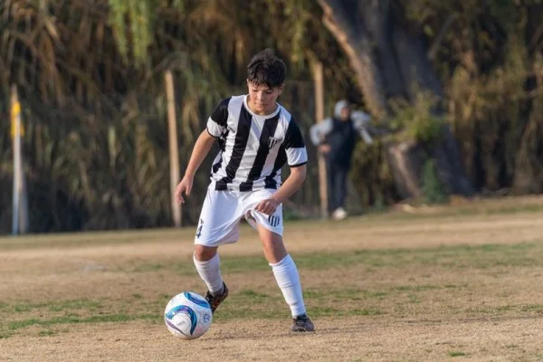 young soccer player dribbling